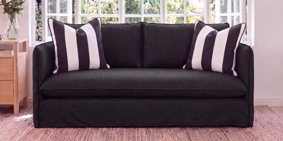 Admiration feather scatter cushion on a grey modular sofa