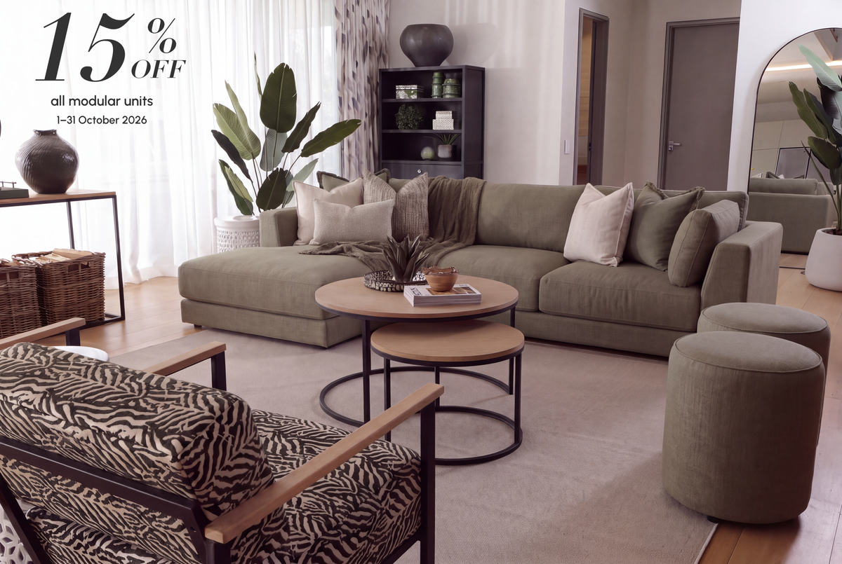 Minx modular sofa in olive in a living room with a zebra-print armchair