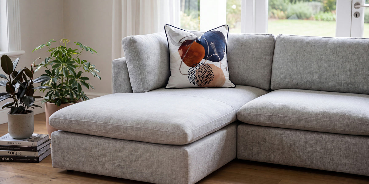 Admiration feather scatter cushion on a grey modular sofa